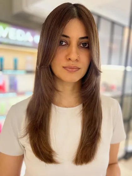 A classic face-framing layered cut is always in style. Paired with a two-tone highlight blend, this look is chic, polished, and incredibly flattering.