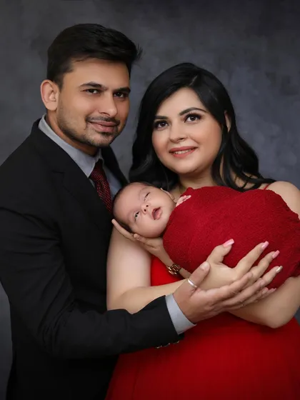 A close-up family portrait where the baby is awake and looking at the camera. I work at the baby's pace, capturing both sleepy and alert moments.
