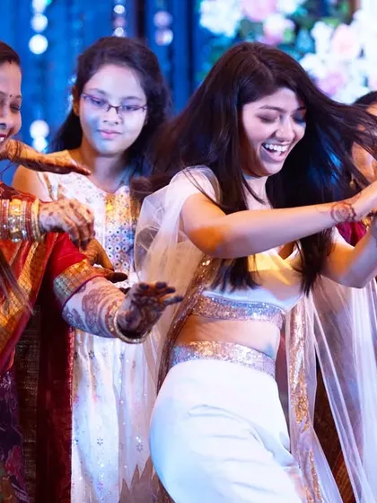 The bride's side takes over the dance floor. This shot is full of energy and movement as the bride dances with her family, their joy and excitement lighting up the room.