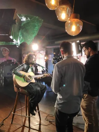 Behind the scenes during a music video shoot. Here I am performing a track on camera, showing how I work with the production crew to get the perfect shot that matches the song's energy and narrative.