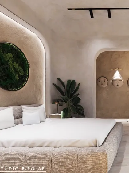 This bedroom in the La Lagune Penthouse is inspired by the Wabi-Sabi philosophy. The space features soft, curved arches, a neutral color palette, and natural textures to create a sanctuary of calm.