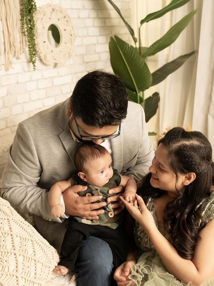 An intimate moment from a family session, where the parents are lovingly interacting with their baby. This candid shot shows the tender connection between them.