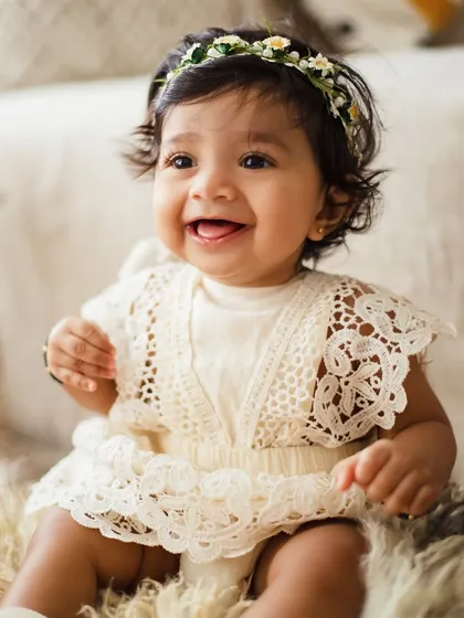 A bright, happy smile from an 8-month-old. This photo perfectly captures the joy and charm of a baby who has mastered sitting up.