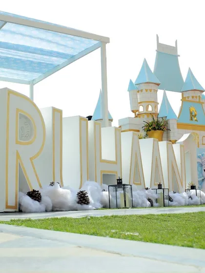 Personalization is key. For this first birthday, I created large-scale, custom-cut letters of the child's name, integrated into a 'Winter Wonderland' theme with a castle backdrop, making the milestone feel truly special.