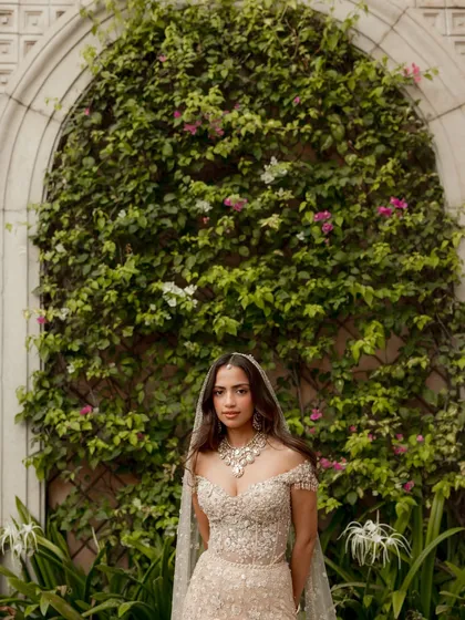 A stunning portrait of our bride Riddhima against a wall of lush greenery. Her effortless elegance and radiant glow were the inspiration for the entire celebration we designed for her.
