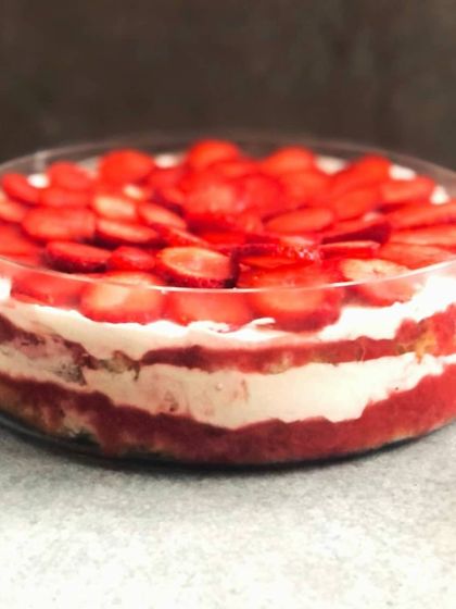 A side view of my Strawberry & Cream Cheese winter trifle, showing the lovely layers of red berry compote, white cream, and soft cake.