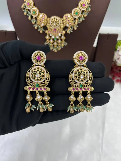 A close-up of the earrings from another antique set.