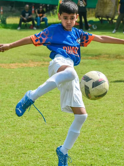 Here, we focus on mastering the fundamentals. This young player demonstrates excellent ball control and kicking technique, skills we build in every session.
