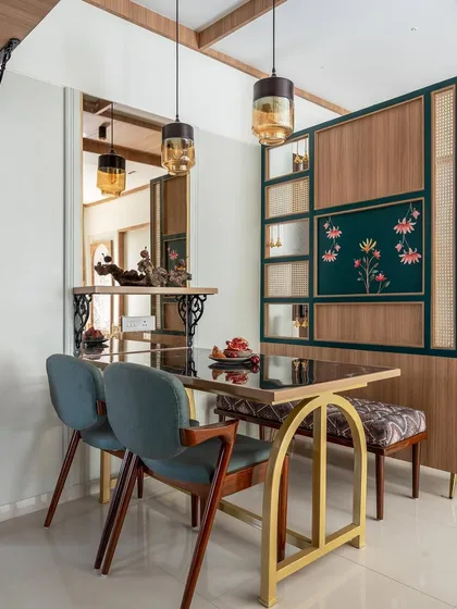 Another angle of the minimalist dining space, highlighting the custom partition with cane and floral details. The pendant lights add a warm, focused glow over the table.