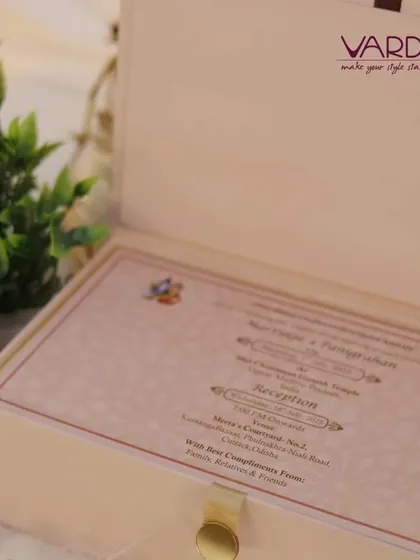 A simple and elegant invitation box in a soft cream color. The focus is on the invitation card itself, which has a clean design and is presented in a high-quality, reusable box.