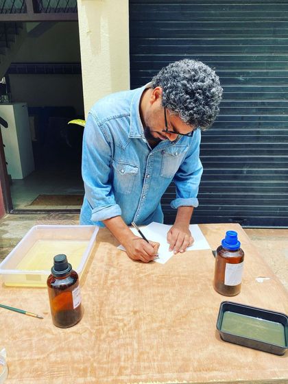 An artist at one of our workshops, learning to coat paper with light-sensitive emulsion for cyanotype printing. We believe in sharing these historic techniques with our community.