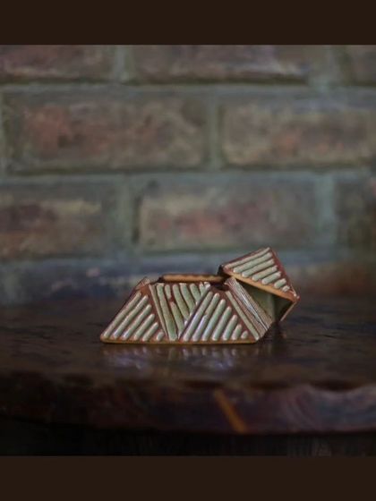 These unique, pyramid-shaped lidded boxes are also part of the KHUMĀR collection, perfect for storing small items or just as a decorative piece.