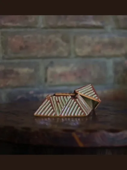 These unique, pyramid-shaped lidded boxes are also part of the KHUMĀR collection, perfect for storing small items or just as a decorative piece.