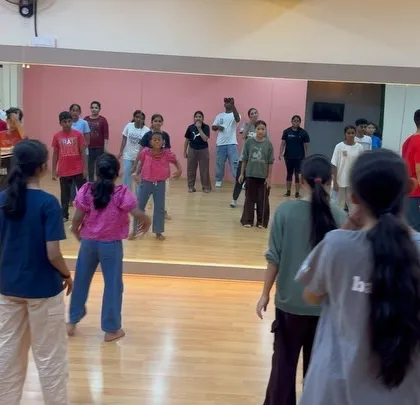 A wide view of the kids' class, showing them spread out and ready to learn the next part of the choreography.