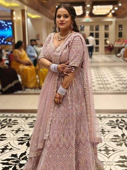 This client chose a lovely lavender-pink lehenga with geometric silver embroidery for her event. It’s a modern and elegant rental option.