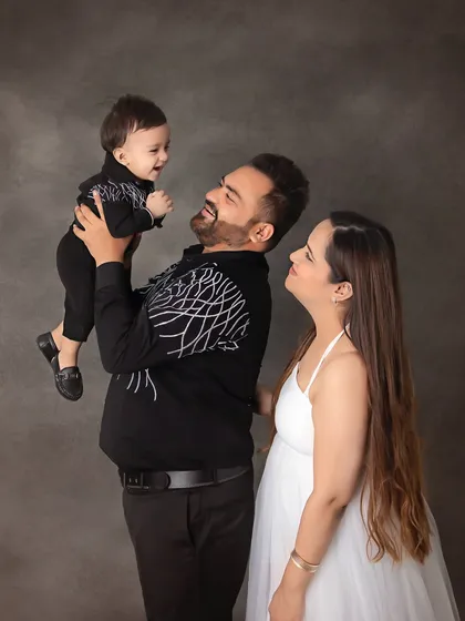 A playful and joyful family moment. Lifting the little one up always brings out the biggest smiles from everyone.