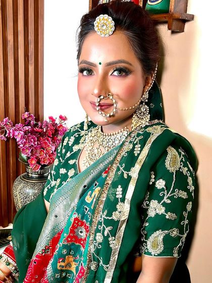 Another angle of the green lehenga look, showing the intricate details of the outfit and the beautiful, traditional makeup.