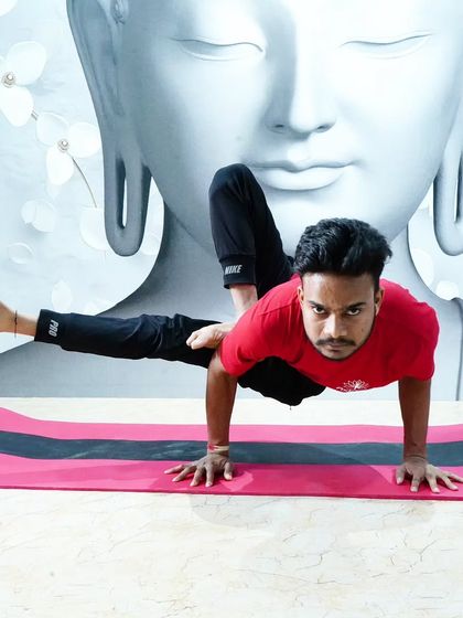 A powerful arm balance, Eka Pada Koundinyasana II, demonstrating core strength and focus.