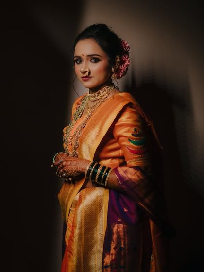 An artistic portrait of the bride in profile, with deep shadows creating a moody and sophisticated atmosphere that highlights her features.