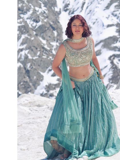 A beautiful three-quarter shot of the model in our green lehenga.