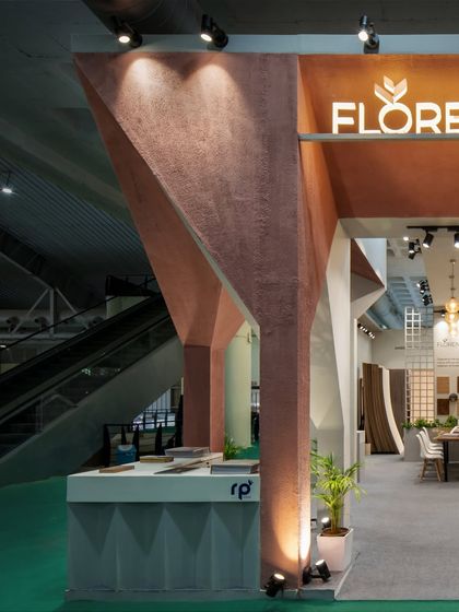 The angular, sculptural quality of the RP Plywood pavilion's structure is emphasized in this shot. The design creates a powerful brand statement through its unique architectural form.