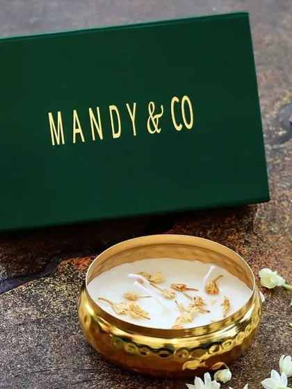 The decorative gold Urli candle in a captivating Jasmine (Mogra) fragrance, crafted with non-toxic soy wax.