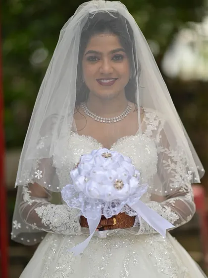 A beautiful portrait of the bride. The soft lighting highlights the glowing skin and the delicate shimmer on her eyes.