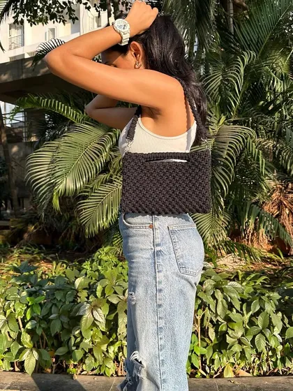 Meet our super versatile 3-way macrame bag, shown here as a shoulder bag. This is one of our favorite designs because it adapts to your needs, easily converting into a clutch or a cross-body sling. It's the perfect all-in-one accessory.
