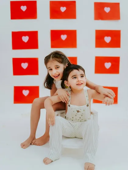 A quiet moment together. This photo captures the gentle and loving side of their sibling relationship.