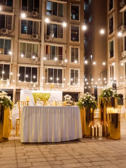 An elegant 79th birthday celebration under the stars. We used a combination of golden decor, crisp white florals, and a canopy of string lights to create a sophisticated and warm outdoor setting.
