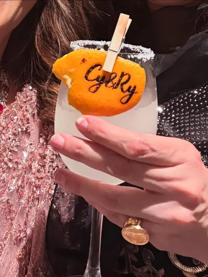 It's the personal touches that make an event unforgettable. We love creating unique details like this custom-stamped orange peel garnish, featuring the couple's initials, to make their signature cocktail truly their own.