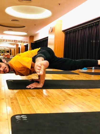 Koundinyasana II, a flying splits arm balance that demonstrates a high level of strength and flexibility.