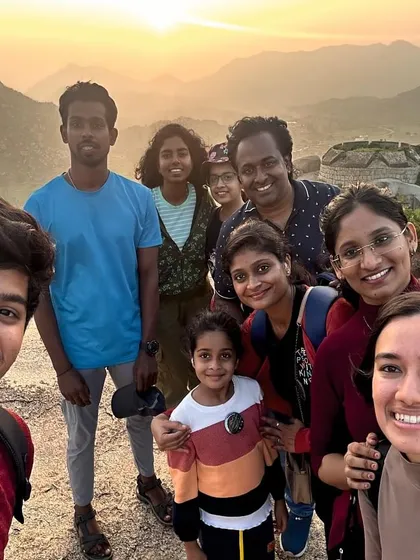 A family enjoying our Adiyogi day trip, which often includes a visit to nearby hills like Gudibande.