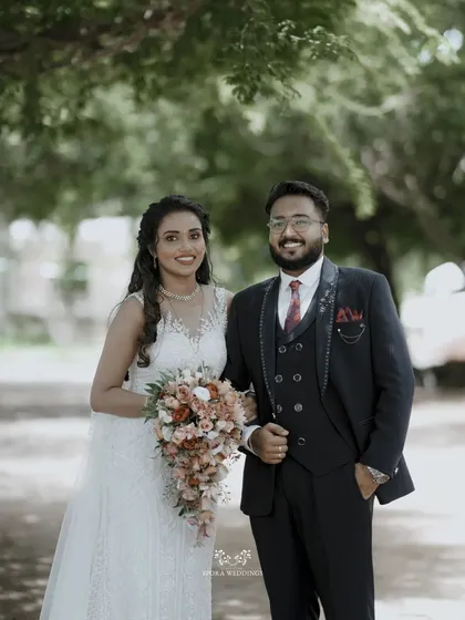 The happy couple posing together in a natural outdoor setting, their smiles reflecting the joy of the day.