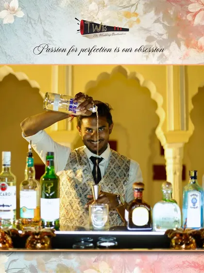 A bartender with a confident smile, expertly pouring a drink at a welcome dinner in Ranthambore.