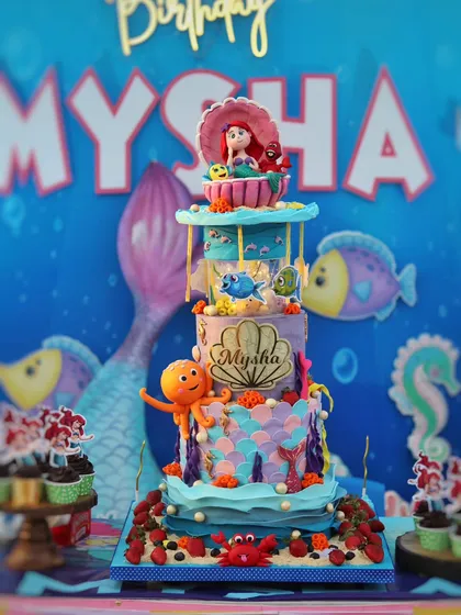 A magical multi-tier Little Mermaid cake, complete with a full dessert table setup. I handcraft all the fondant characters like Ariel, Flounder, and Sebastian to bring the underwater kingdom to life.