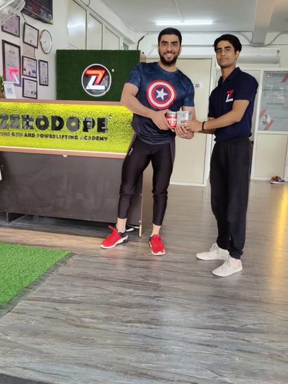 Receiving my prize after the squat competition. Small wins keep the motivation high.