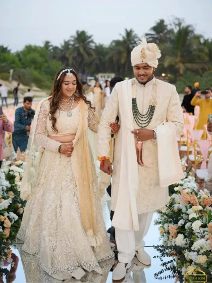 Walking down the aisle at their beach wedding. The bride's makeup is designed to be long-lasting and beautiful, even in the coastal climate.