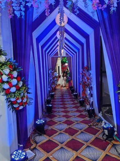 I create grand entrances that make a statement. This tunnel-style entrance for an engagement ceremony uses custom draping and a series of uplights to build excitement and provide a stunning photo opportunity for guests as they arrive.