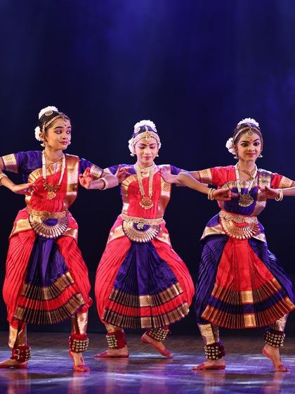 A group of five students performing in perfect unison, a testament to their rigorous training and teamwork.