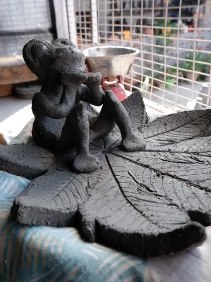 Another look at this fantastic sculpture, showing the incredible detail in the leaf and the relaxed posture of the character. It's a story in clay.
