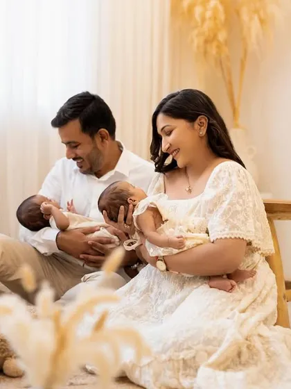 Another beautiful moment from the twin family session, showing the parents interacting lovingly with their newborns. My studio provides a relaxed environment for these gentle family portraits.