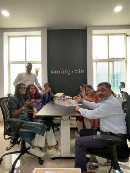 A happy moment in the studio with my team. We are gathered around a physical model, discussing the design and celebrating the collaborative process that brings our projects to life.