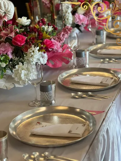 A beautifully set table is the first promise of a wonderful meal. I work to ensure the tablescape, with its vibrant flowers and elegant dinnerware, speaks the language of celebration.