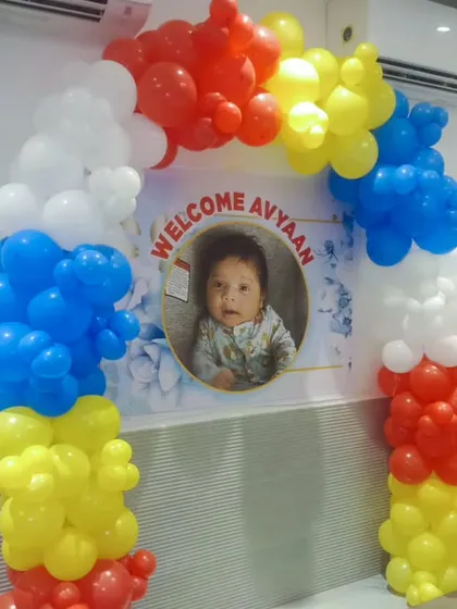 A colorful welcome arch with a personalized photo banner. The balloon arch uses primary colors for a bright and cheerful look.