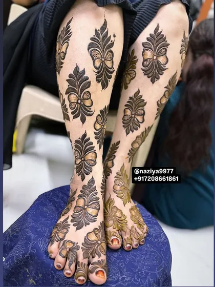 Henna isn't just for hands. I love doing full leg designs like this one, where I used a unique repeating bow motif. It's a modern and playful take on traditional leg mehandi.