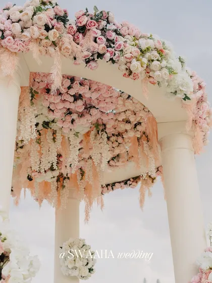 A close-up of the floral arch from the Dubai wedding, showing the intricate arrangement of cascading pastel flowers.