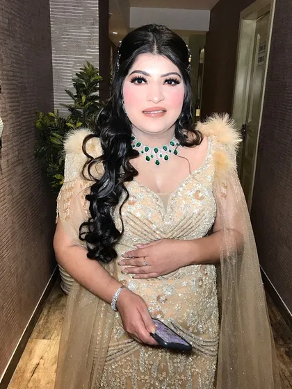 A full-length shot of the engagement bride in her golden gown, her emerald necklace adding a beautiful pop of color.