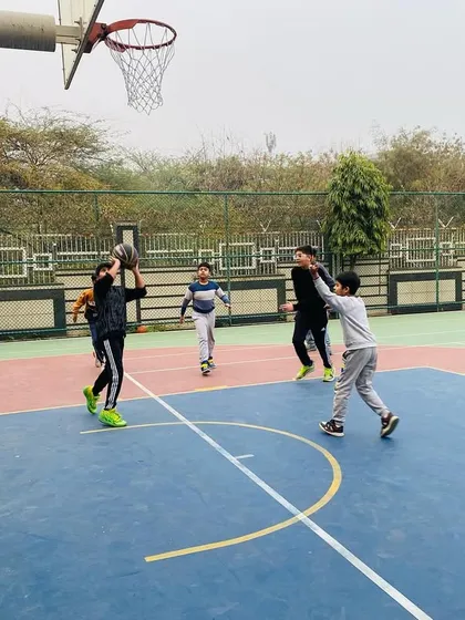 A young player learns to shoot over a defender.