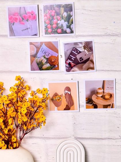 The aesthetic prints displayed on a white brick wall, showing how they can be used as room decor. This is a perfect example of in-context product photography.